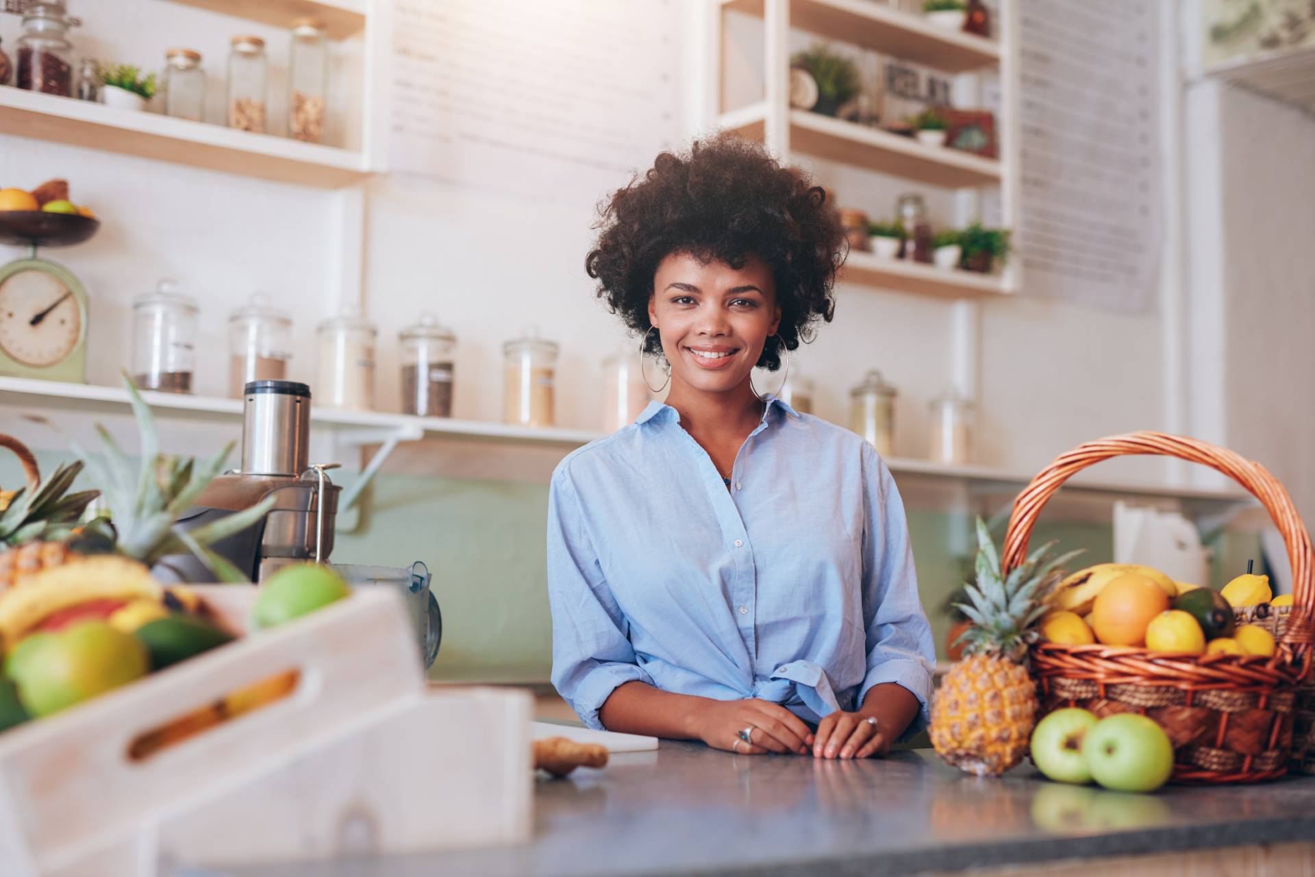 proud young female juice bar owner
