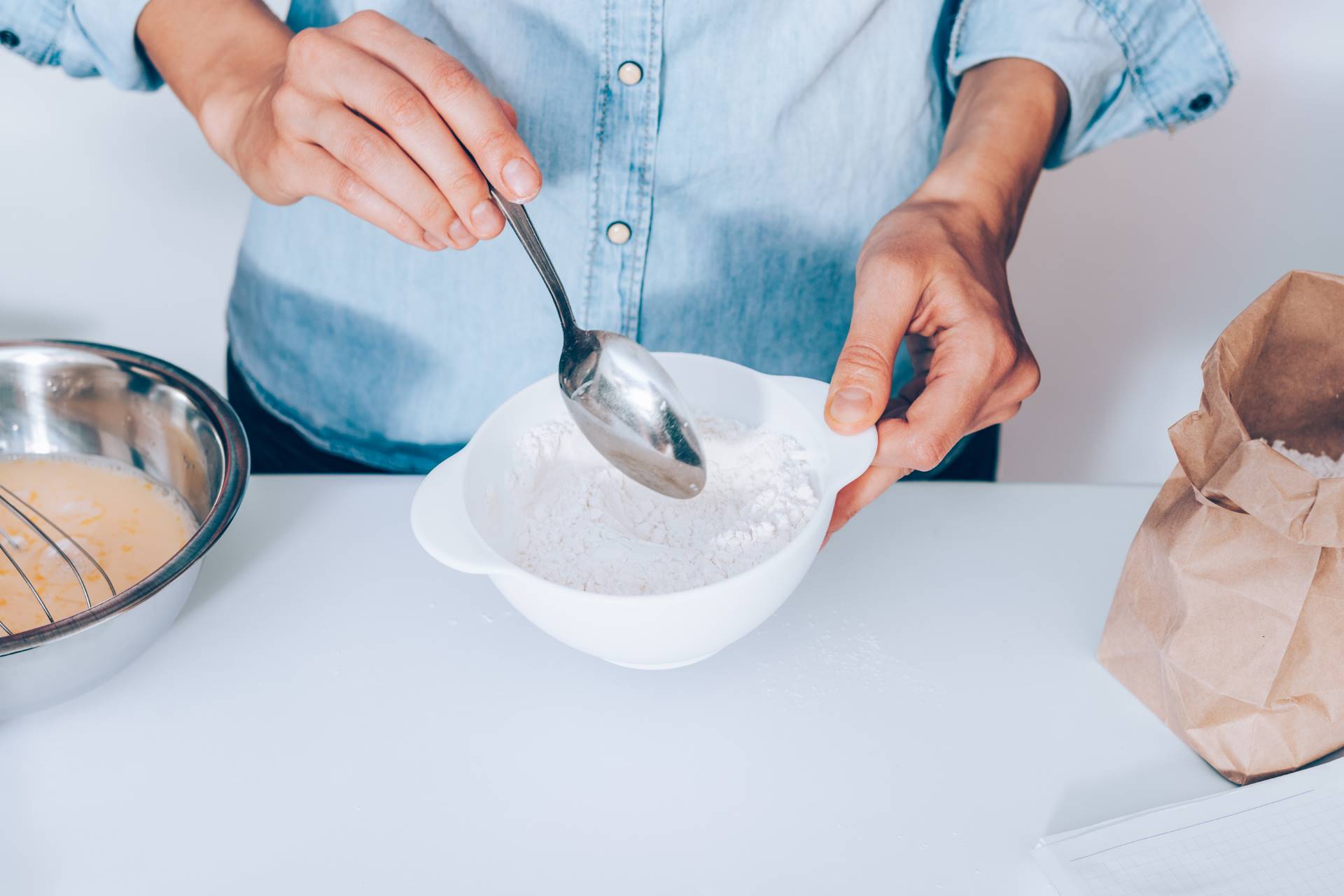 young woman mixing flour to make dough